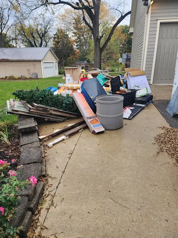 Dumpster being loaded with debris for 12 Yard Dumpster Rental in Black River Falls